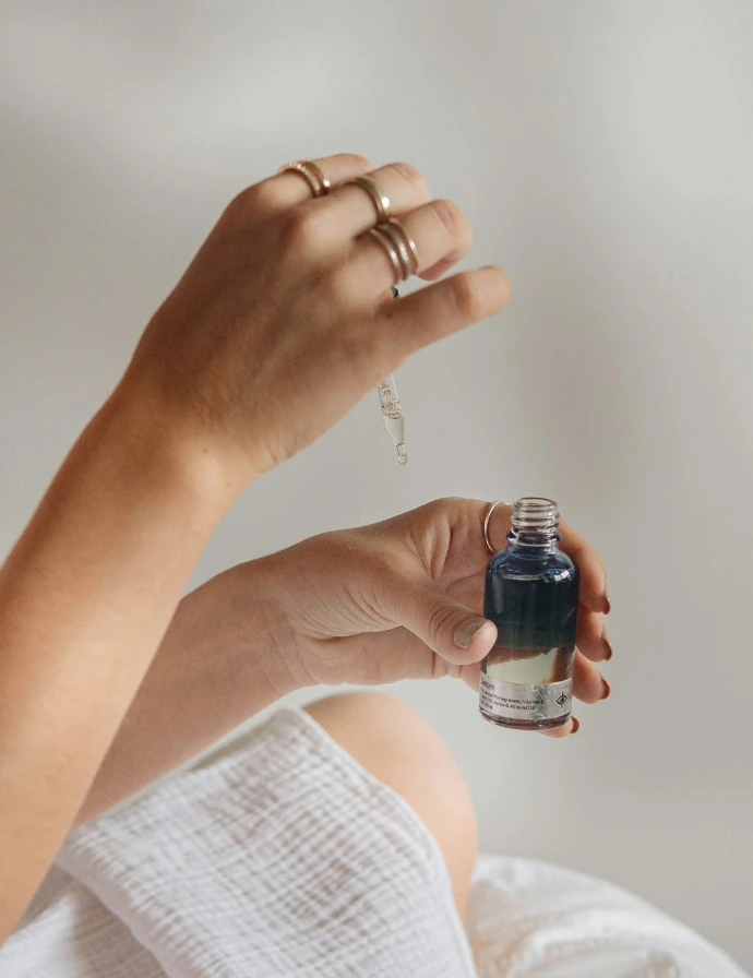 person holding black glass bottle